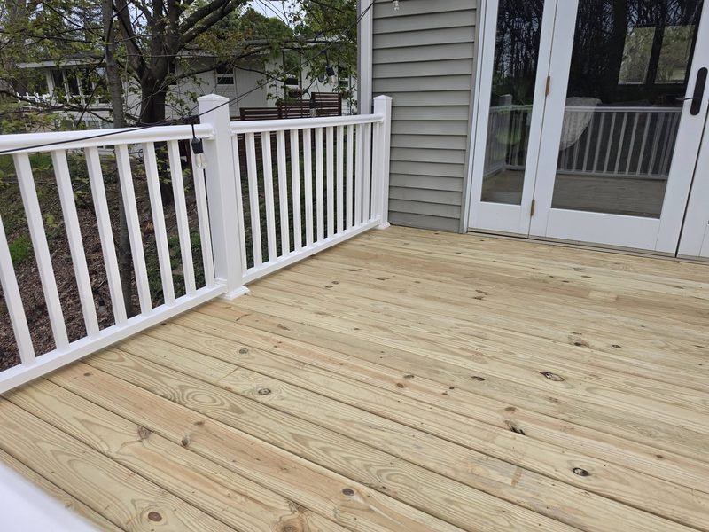 Freshly built back deck with new decking and white railing
