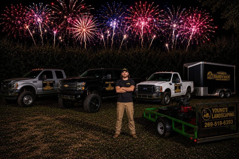 The Young's Handyman Services crew with their trucks and landscaping trailer